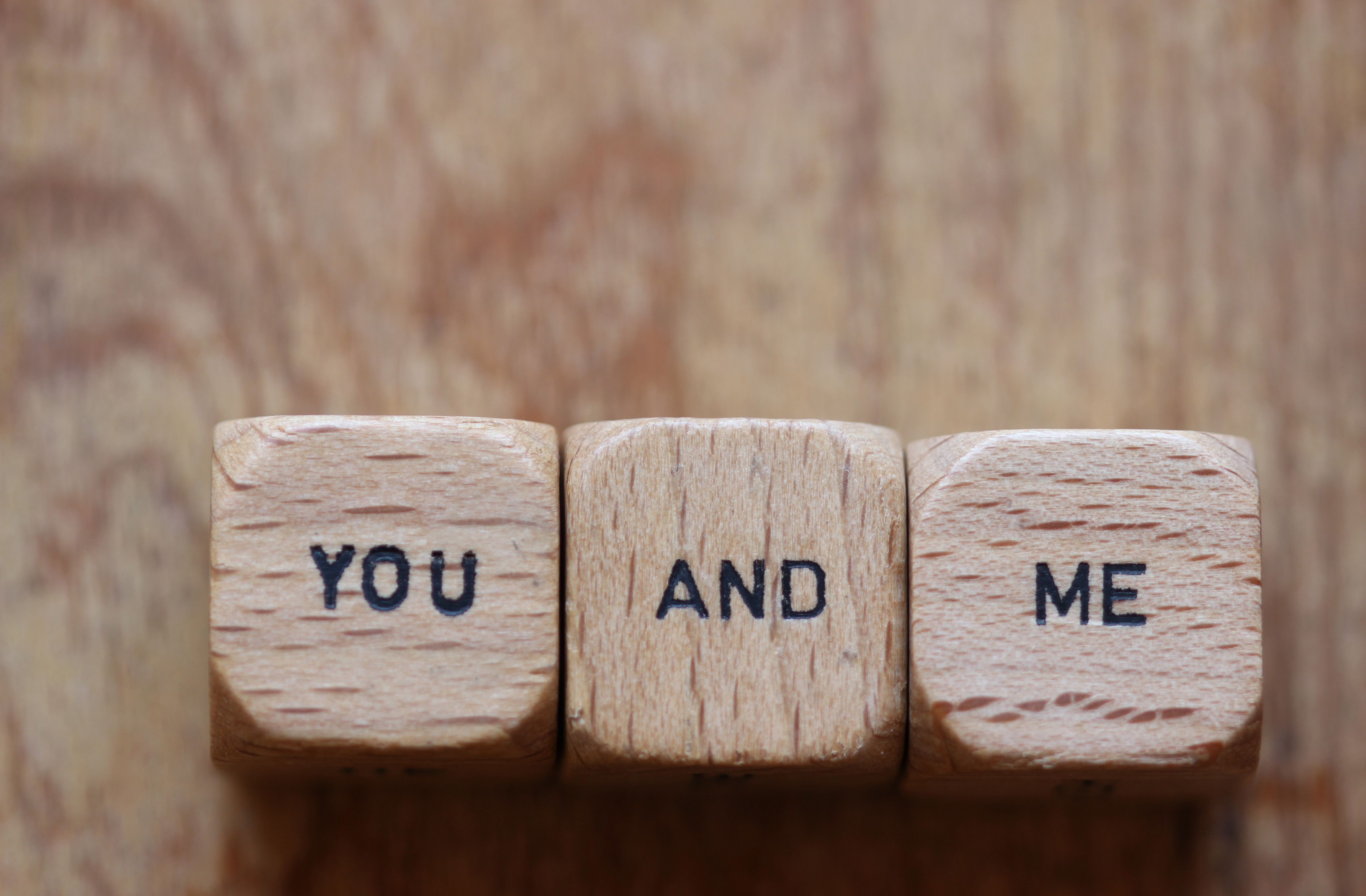 "You and me" printed on three wood dice with room for copy on wood background